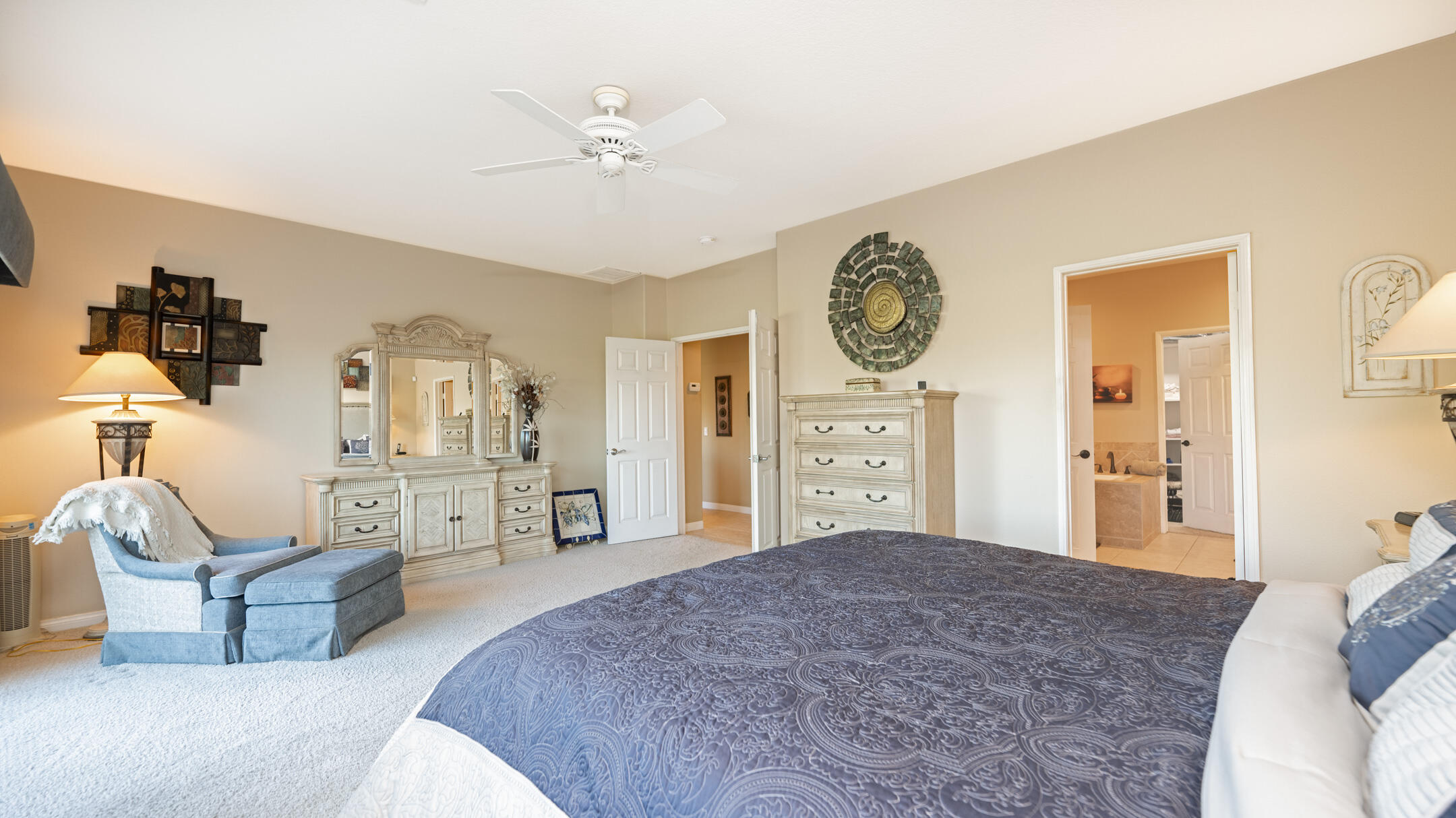 80290 Pebble Beach Drive Indio, CA 92201 - Photo 16 of 44 a spacious bedroom with a bed and a chandelier