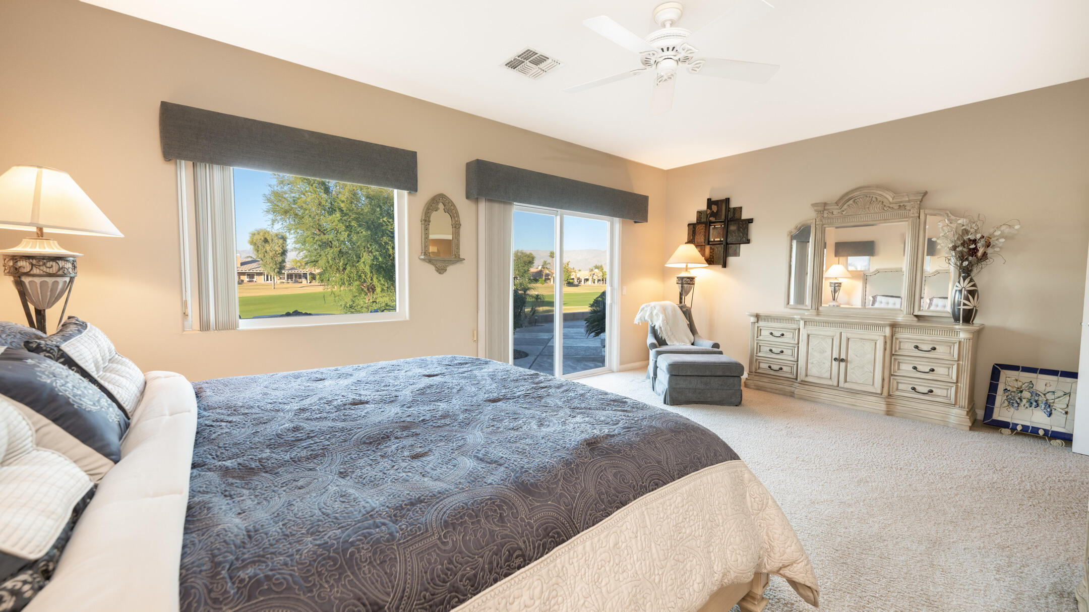 80290 Pebble Beach Drive Indio, CA 92201 - Photo 17 of 44 a bedroom with a large bed and a chandelier