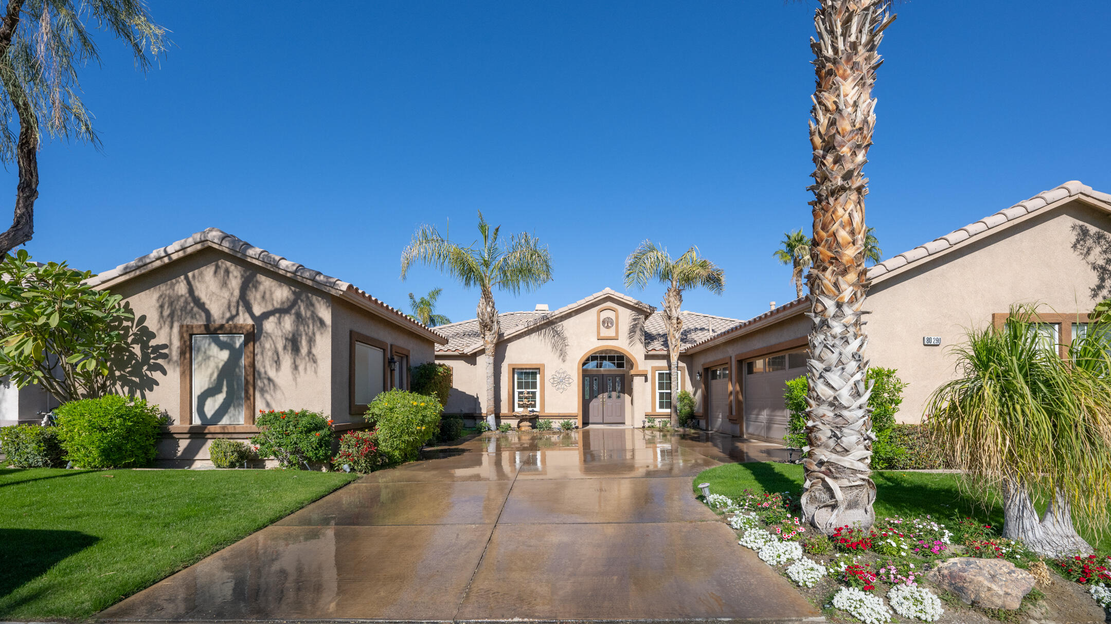 80290 Pebble Beach Drive Indio, CA 92201 - Photo 2 of 44 a front view of a house with garden