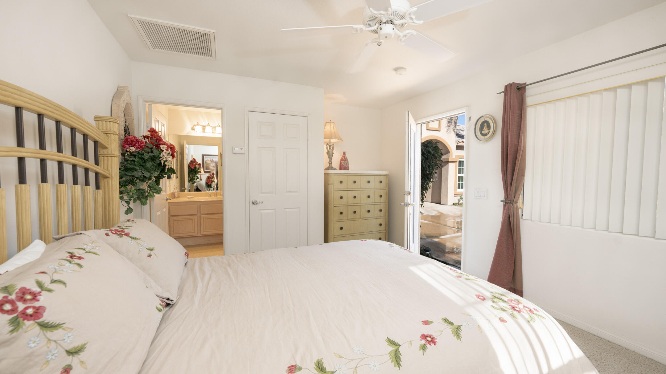 80290 Pebble Beach Drive Indio, CA 92201 - Photo 25 of 44 a bedroom with a bed and a chandelier