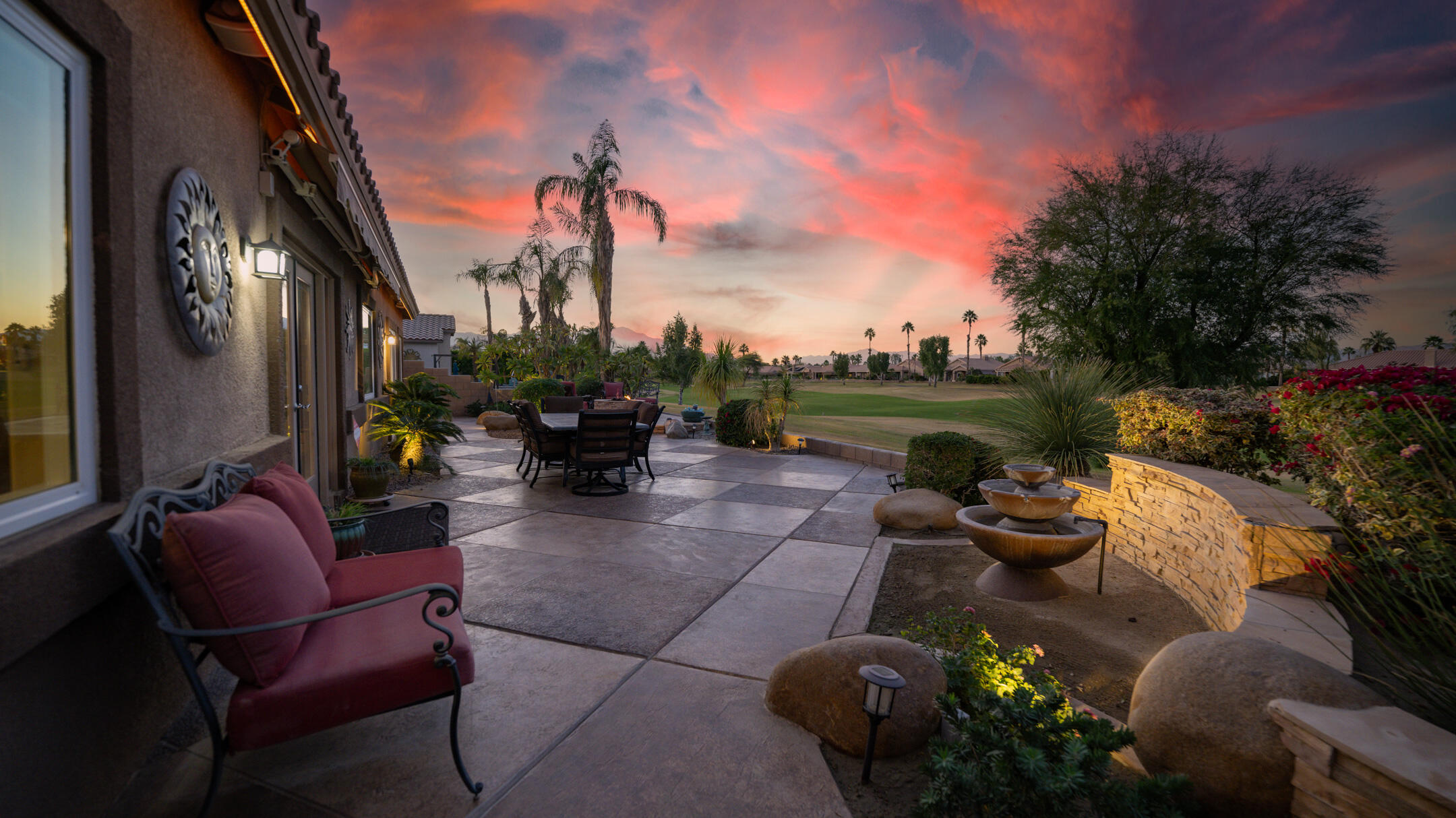 80290 Pebble Beach Drive Indio, CA 92201 - Photo 34 of 44 a view of a patio with couches table and chairs and potted plants