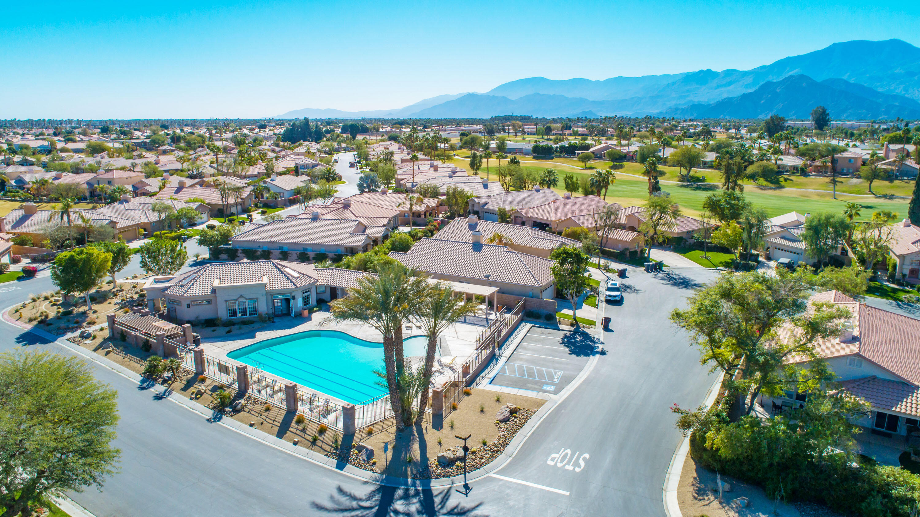 80290 Pebble Beach Drive Indio, CA 92201 - Photo 37 of 44 an aerial view of a city with lots of residential buildings and mountain view in back