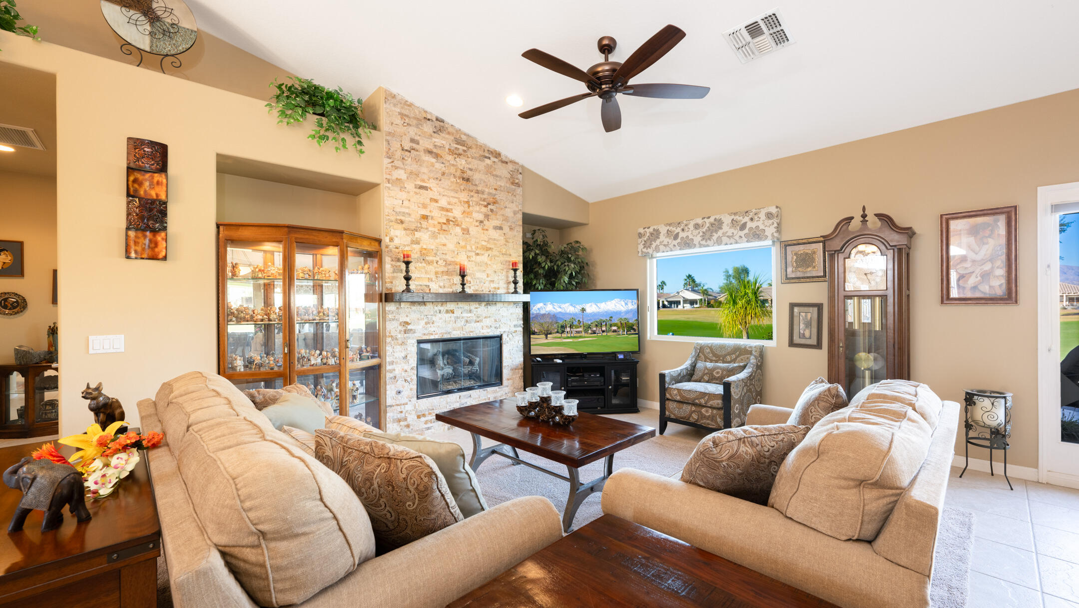 80290 Pebble Beach Drive Indio, CA 92201 - Photo 7 of 44 a living room with furniture a fireplace and a flat screen tv