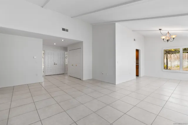 a view of an empty room and a window