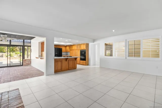 a large white kitchen with a large window