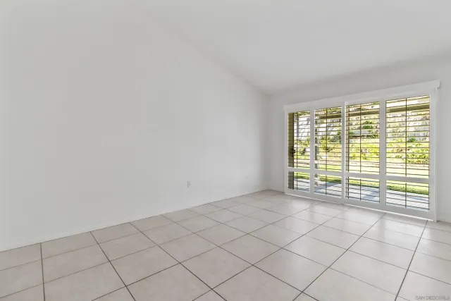 a bathroom with a granite countertop sink a mirror and shower