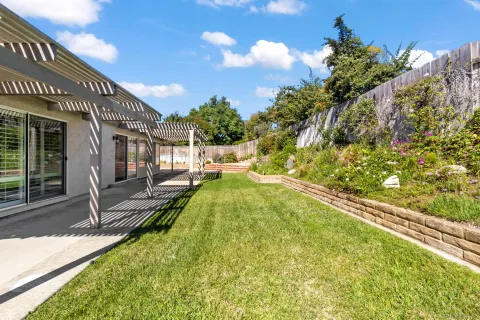 a view of a backyard and swimming pool