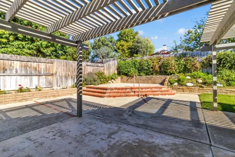 a view of a house with a yard and sitting area