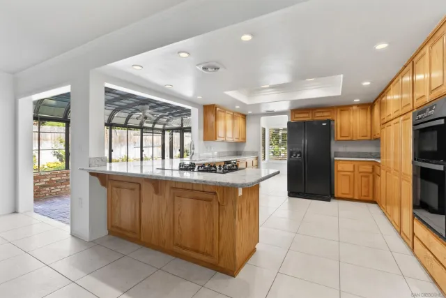 a kitchen with stainless steel appliances granite countertop a refrigerator and a stove
