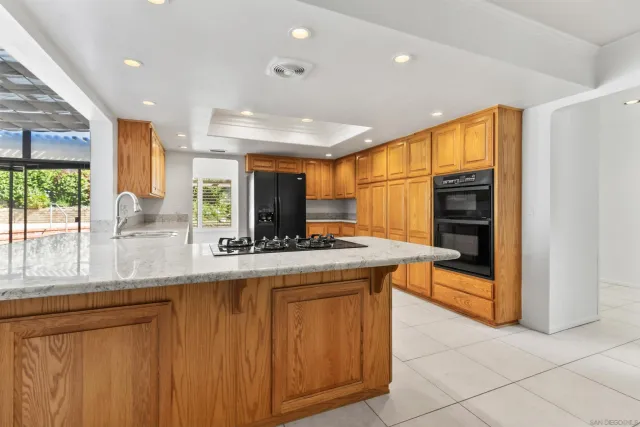 a kitchen with stainless steel appliances granite countertop a stove and a refrigerator