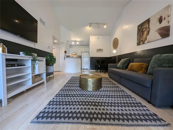 a kitchen with stainless steel appliances granite countertop a sink and a refrigerator