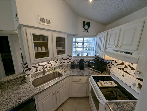 a kitchen with a sink stove and cabinets