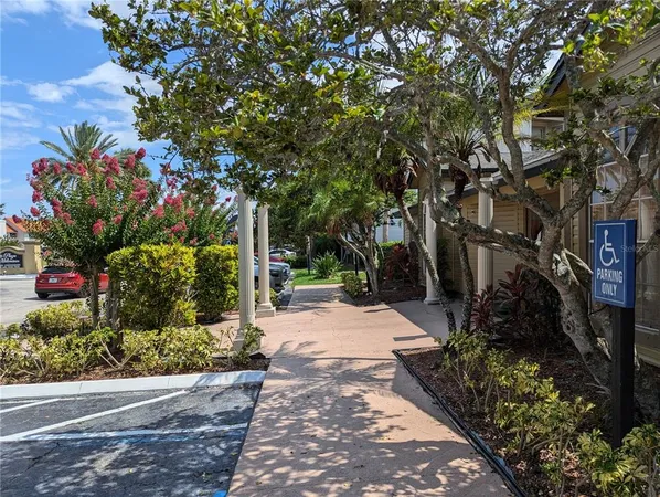 a front view of a house with a yard and fountain