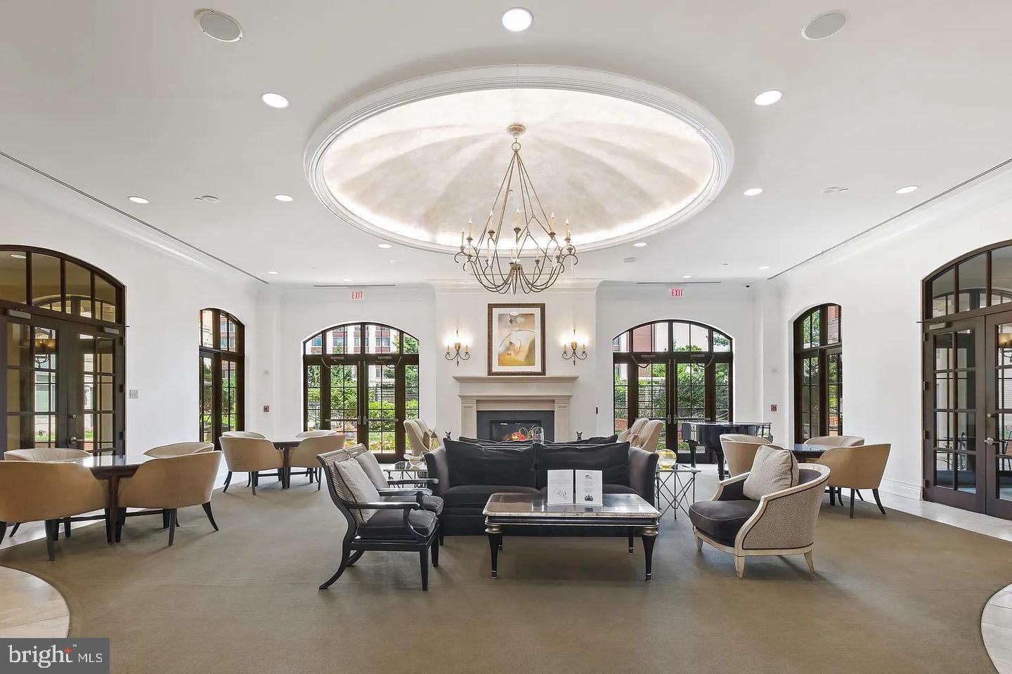 11710 Old Georgetown Road, Unit 602 North Bethesda, MD 20852 - Photo 5 of 22 a living room with furniture a chandelier and a dining table