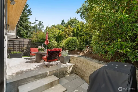 a view of a patio with table and chairs and potted plants