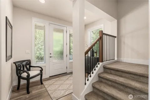 a view of staircase with furniture and a window