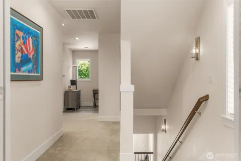 a view of a hallway with paintings on the wall