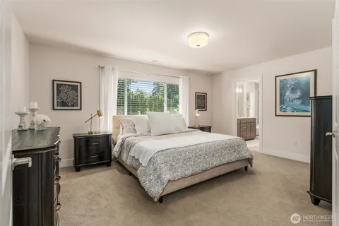 a bedroom with a bed and a dresser with window