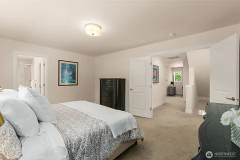 a spacious bedroom with a bed and a couch