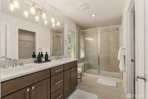 a bathroom with a shower sink vanity granite and shower