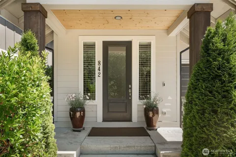a front view of a house with a potted plant