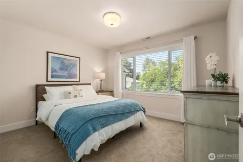 a bedroom with a large bed and a window