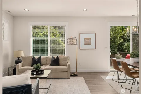 a living room with furniture and floor to ceiling windows