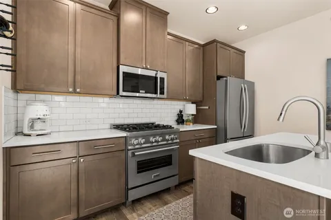 a kitchen with a sink stove and refrigerator