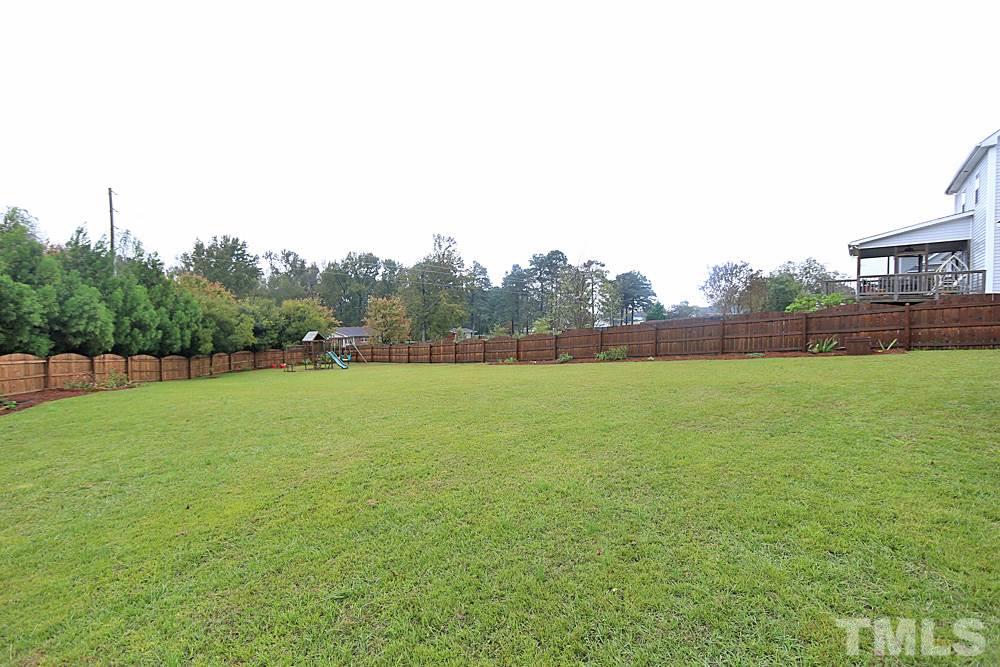 19 Baldwin Ridge Court Willow Spring, NC 27592 - Photo 23 of 25 Spacious back yard with privacy fence