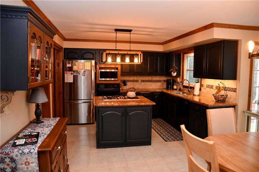 110 Firethorn Road Baden, PA 15005 - Photo 15 of 43 a kitchen with stainless steel appliances kitchen island granite countertop a refrigerator a stove top oven a sink and dishwasher
