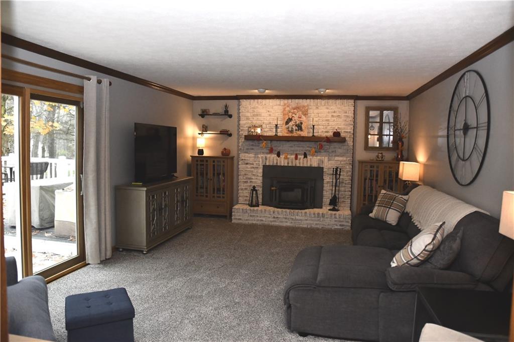 110 Firethorn Road Baden, PA 15005 - Photo 16 of 43 a living room with furniture a flat screen tv and a fireplace