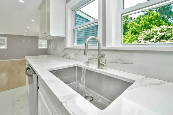 a kitchen with a sink a counter top and a stove