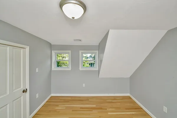 a view of room with window and hardwood floor