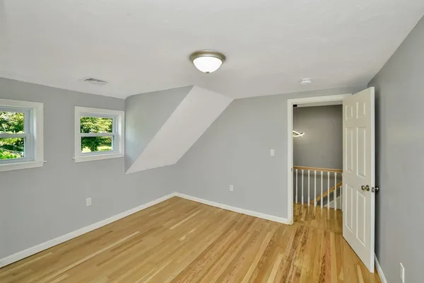 a view of a room with wooden floor and a window