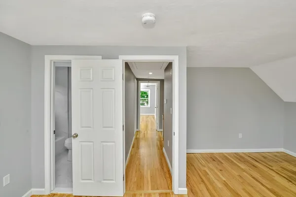 a view of hallway with wooden floor