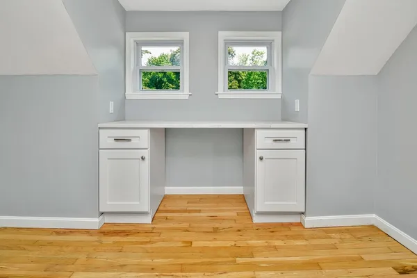 a view of room with window and wooden floor