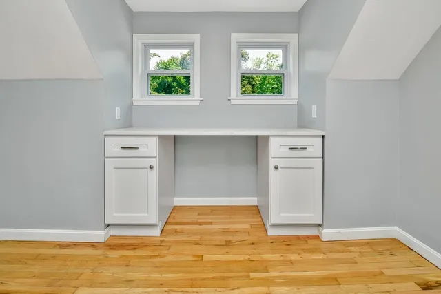a view of room with window and wooden floor