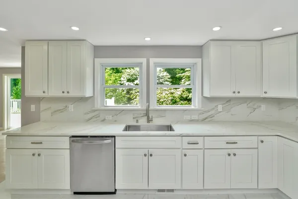a kitchen with white cabinets and a sink