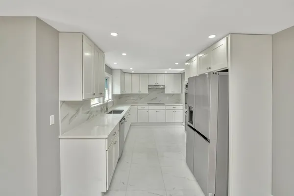a kitchen with a sink stainless steel appliances and cabinets