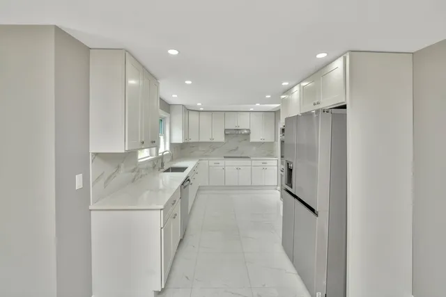 a kitchen with a sink stainless steel appliances and cabinets