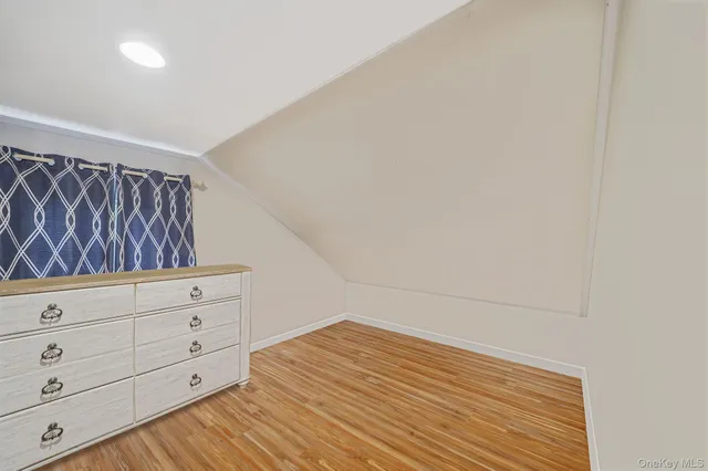 a view of a closet with wooden floor