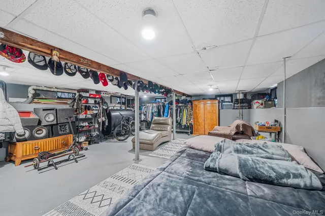 a bedroom with furniture and a flat screen tv