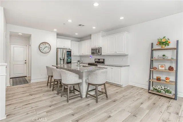 a kitchen with a table chairs and a refrigerator