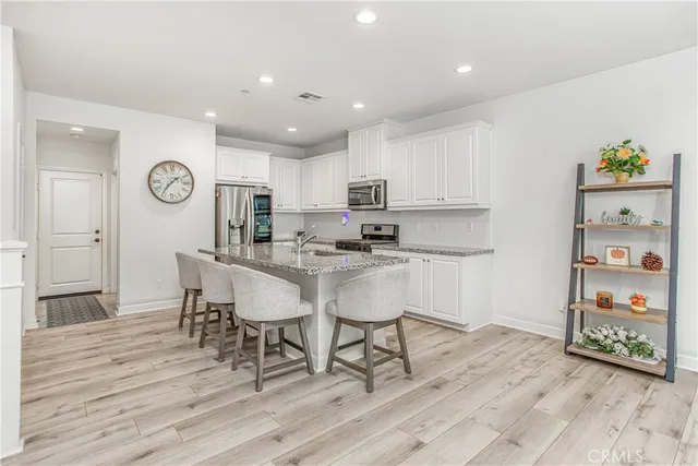 a kitchen with a table chairs and a refrigerator