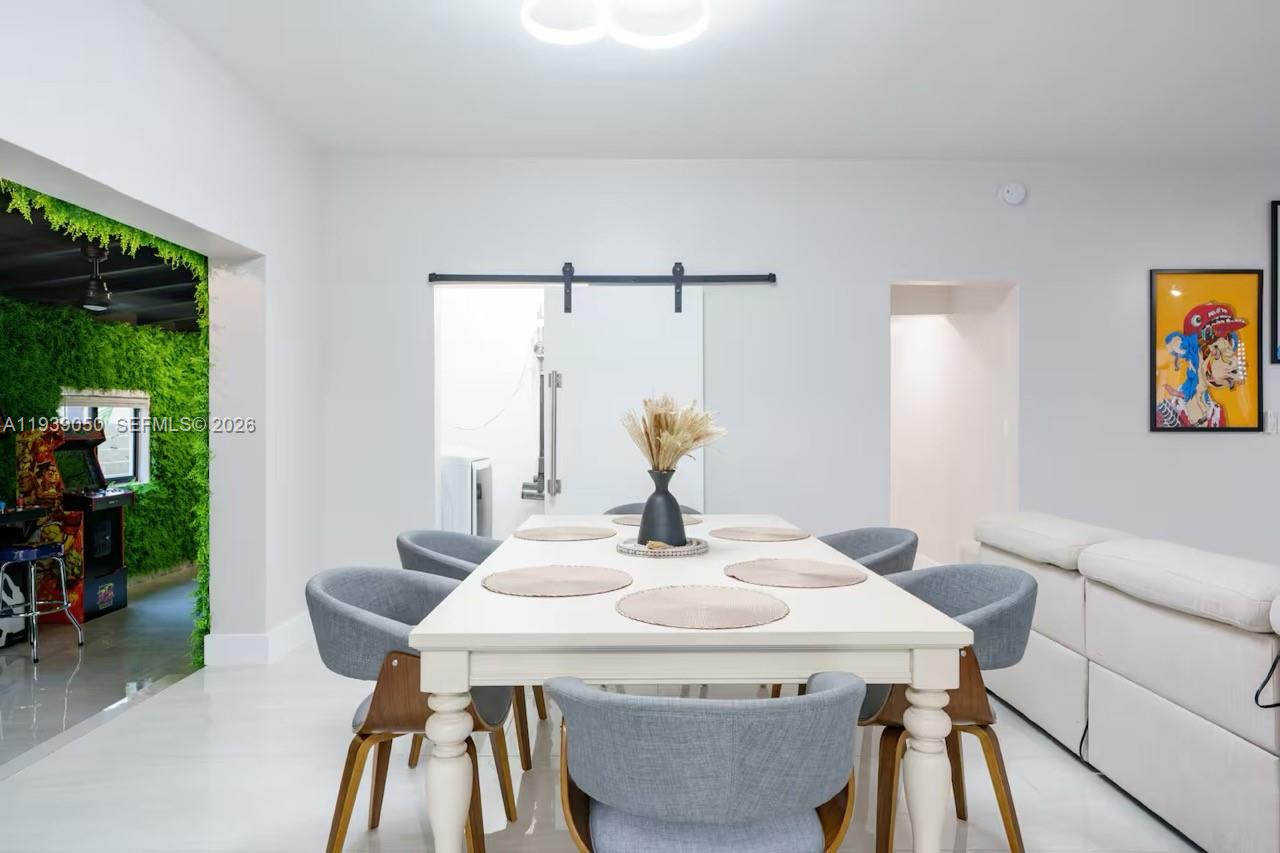 1721 Southwest 11th Terrace Miami, FL 33135 - Photo 11 of 60 a view of a dining room with furniture and wooden floor