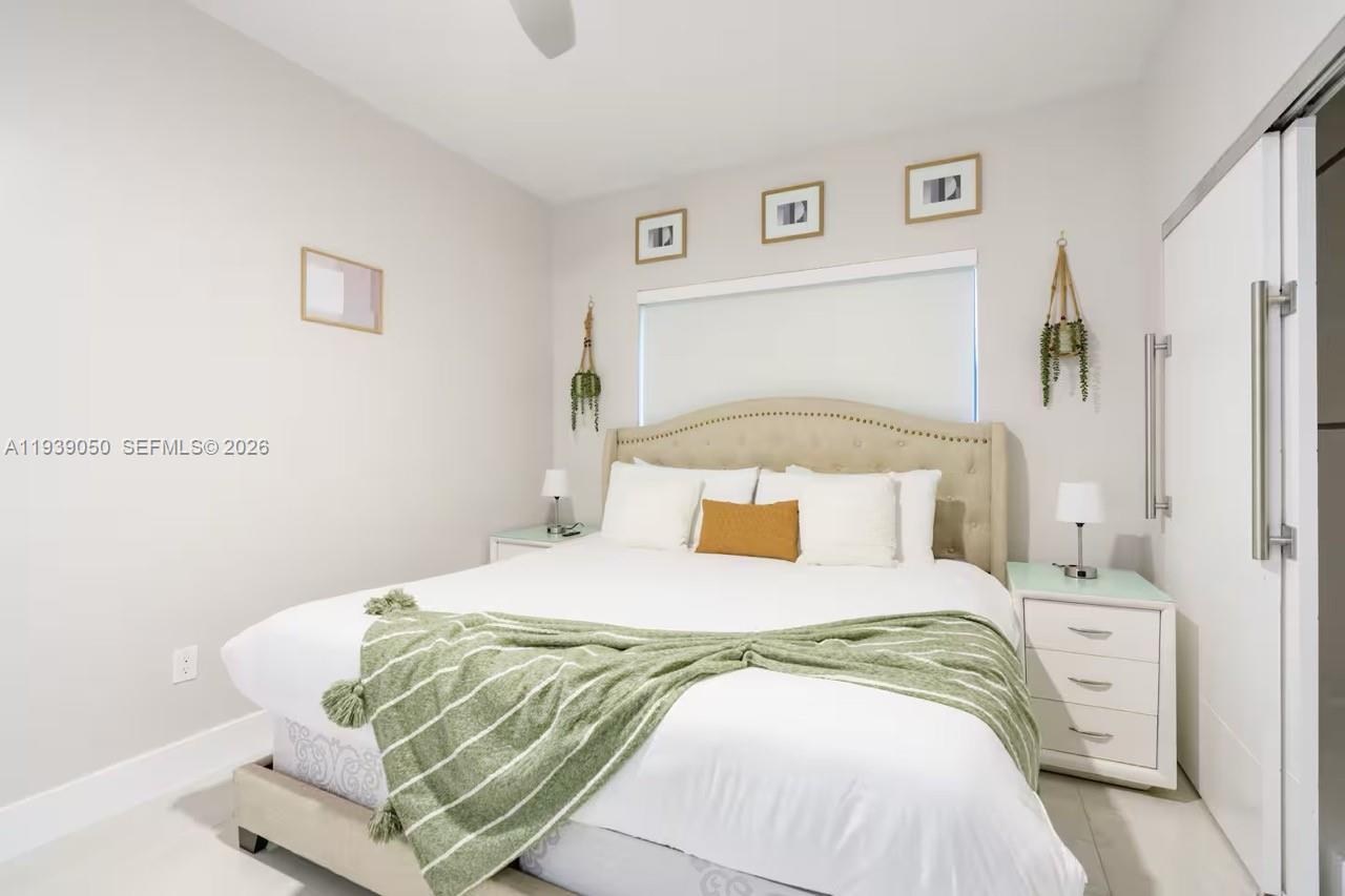 1721 Southwest 11th Terrace Miami, FL 33135 - Photo 21 of 60 a bedroom with a bed and painting on the wall