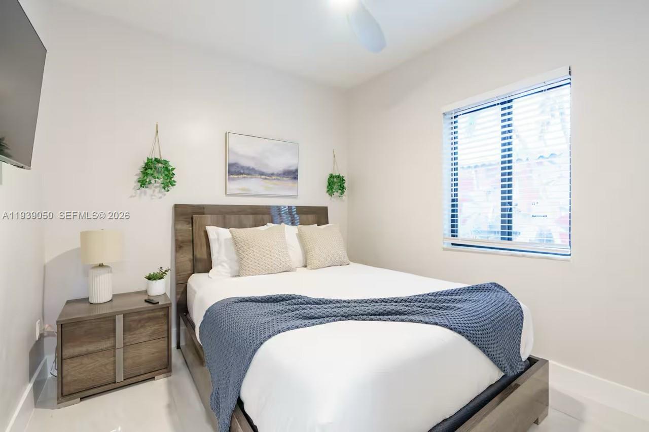 1721 Southwest 11th Terrace Miami, FL 33135 - Photo 23 of 60 a bedroom with a bed and window