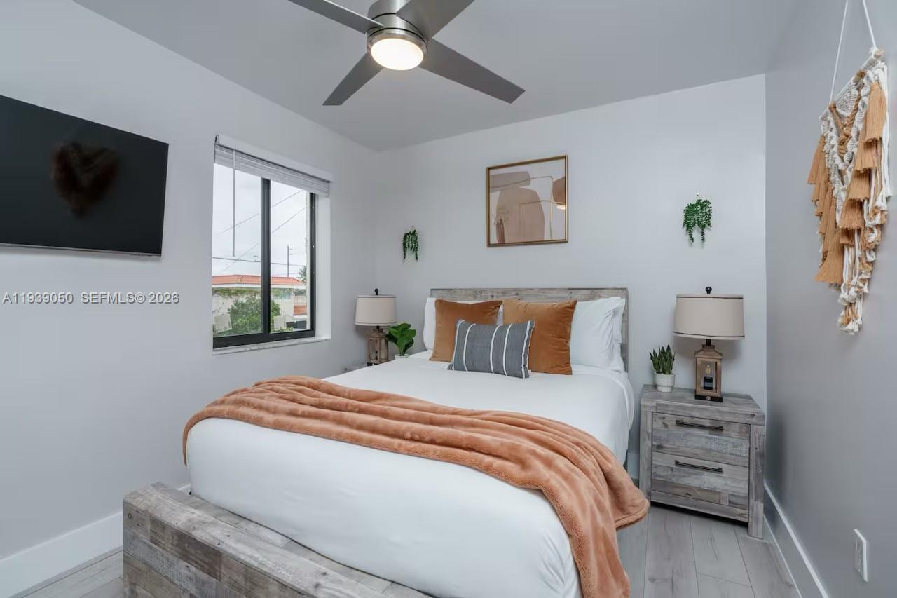 1721 Southwest 11th Terrace Miami, FL 33135 - Photo 35 of 60 a bedroom with a bed and a flat screen tv