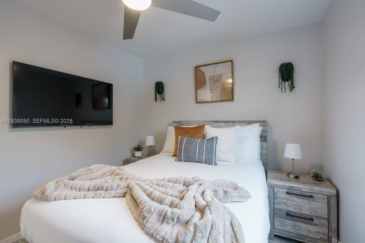 1721 Southwest 11th Terrace Miami, FL 33135 - Photo 43 of 60 a bedroom with a bed and a flat screen tv