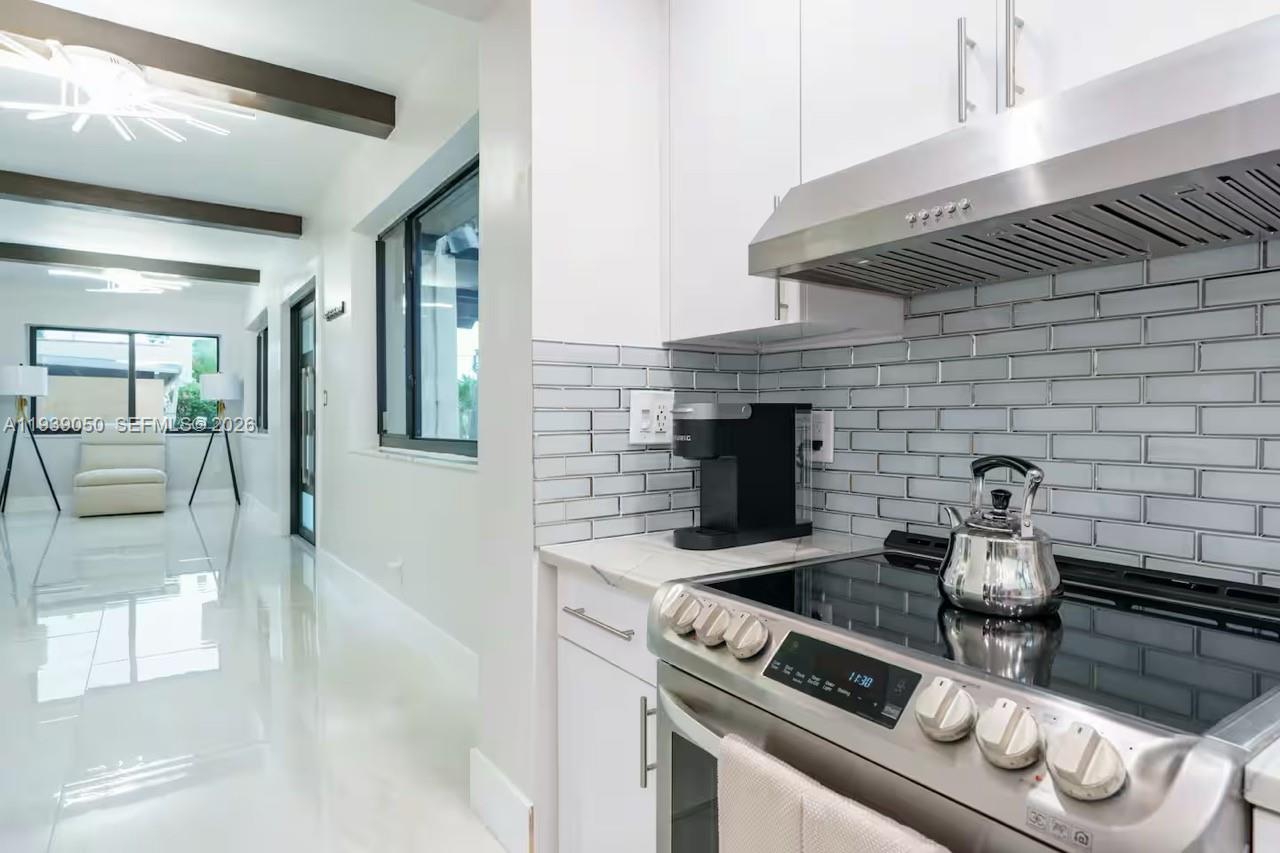 1721 Southwest 11th Terrace Miami, FL 33135 - Photo 5 of 60 a kitchen with a stove and a microwave